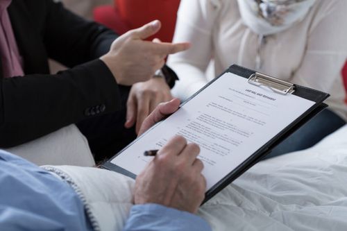 A fairfax estate planning attorney is going over a document with his clients.