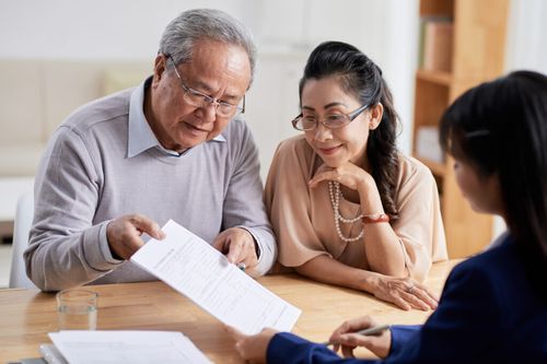 A couple looks over a legal document with an fairfax estate planning attorney